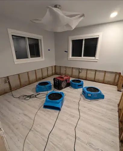 Air movers drying a gutted room during an Alhambra water damage dry-out