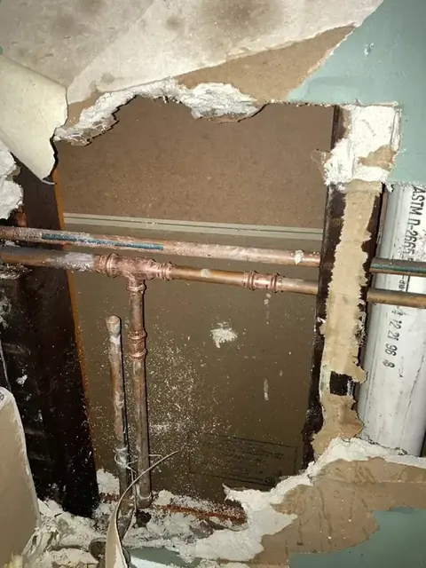 Wall opened to reach leaking copper supply lines in Alhambra
